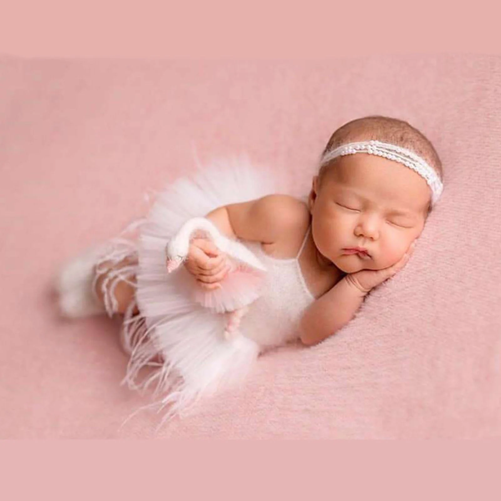 cute baby laying down wearing dress newborn